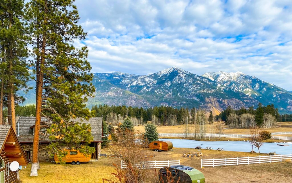 View of trailer cabins and campground with mountains in the background