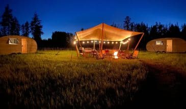 View of campground with bonfire burning at night