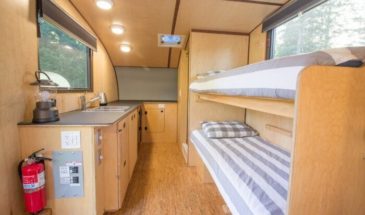 Inside of a cabin with sink, bunk beds, and bathroom