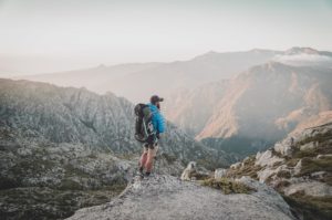 Man standing at the top of the mountain