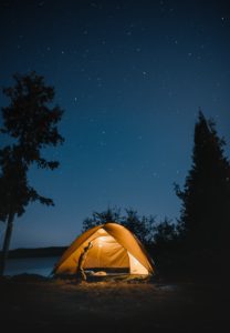 Brown dome tent camping at night in the forest
