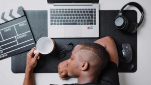 man sleeping on the table due to stress or burnout