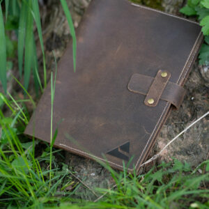 The Recall Guidebook laying in grass.