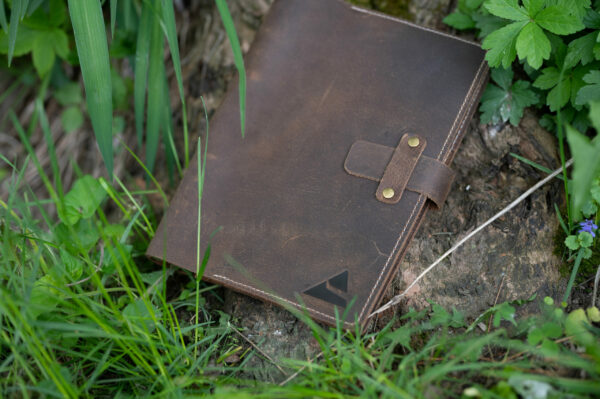 The Recall Guidebook laying in grass.