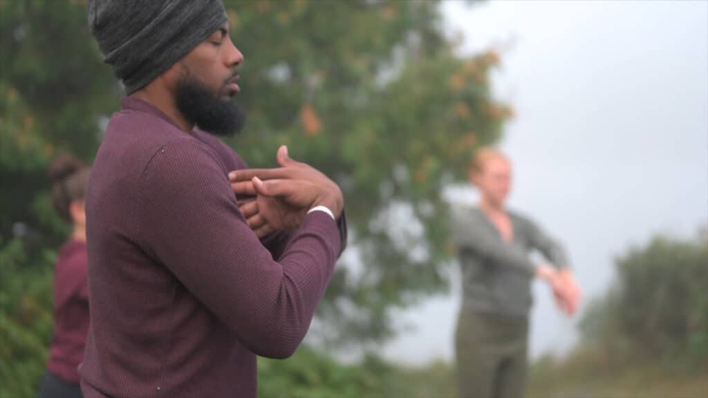 Black man practicing yoga in nature