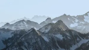 Scenery of mountains with a faded overlay that makes it look cool blue and a bit grainy aesthetic.